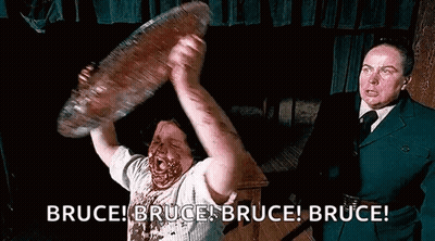 Man With Blood Holding Large Meat GIF