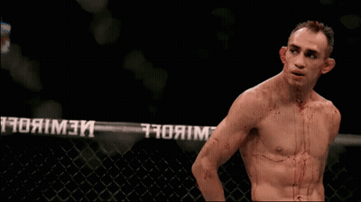 Man With Blood On Chest In Front Of UFC Fence GIF