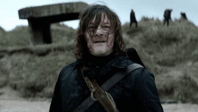 Man With Blood On Face Standing On Grassy Hill GIF