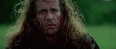 Man With Blood On His Face Standing In Field GIF