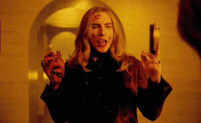Man With Bloody Face Holding Heart And Gun GIF