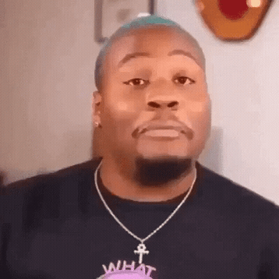 Man With Blue Hair And Beard Wearing Necklace And Earrings GIF