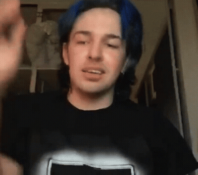 Man With Blue Hair In Black T-Shirt Making Face GIF