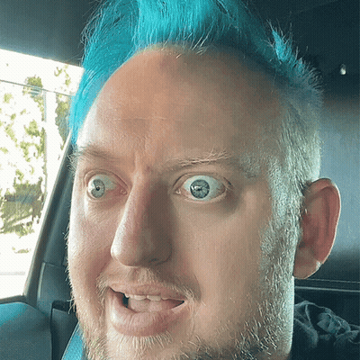Man With Blue Hair Making Funny Face In Car GIF