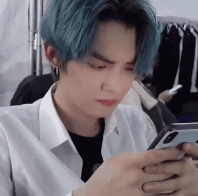 Man With Blue Hair Using Cell Phone GIF