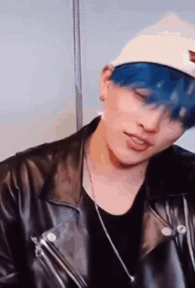 Man With Blue Hair White Hat Leather Jacket And Necklace GIF
