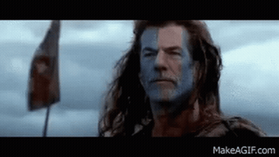 Man With Blue Paint On Face And Flag In Field GIF