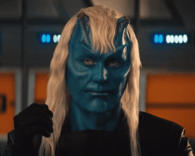Man With Blue Paint On Face And Long Blonde Hair GIF
