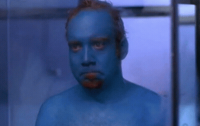 Man With Blue Painted Face Looking At Camera GIF