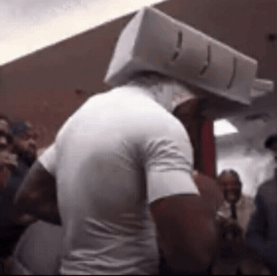 Man With Box On Head In Crowd GIF