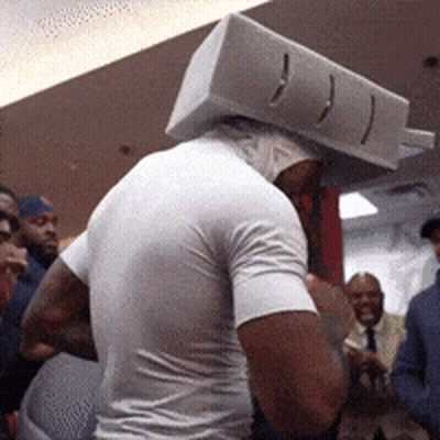 Man With Box On Head In Front Of Crowd GIF
