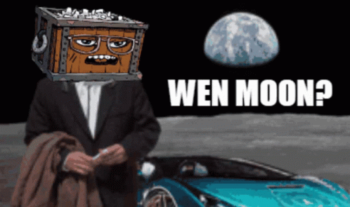 Man With Box On Head Sitting In Front Of Blue Car With Wen Moon GIF