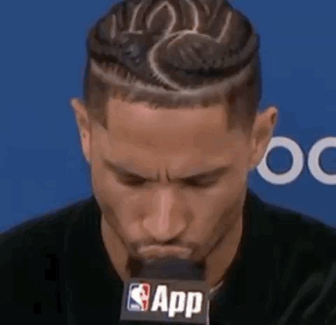 Man With Braided Hairstyle At Microphone GIF