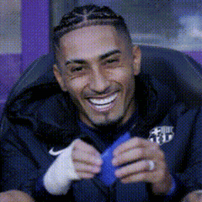 Man With Braids Smiling Holding Blue Object GIF