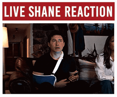 Man With Broken Arm Sitting Under Shane Reaction Banner GIF