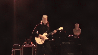 Man With Bucket On Head Playing Guitar On Stage GIF