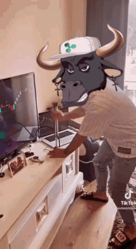 Man With Bull's Head Standing In Front Of TV GIF