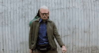 Man With Cane Standing In Front Of Wooden Wall Saying Forever GIF