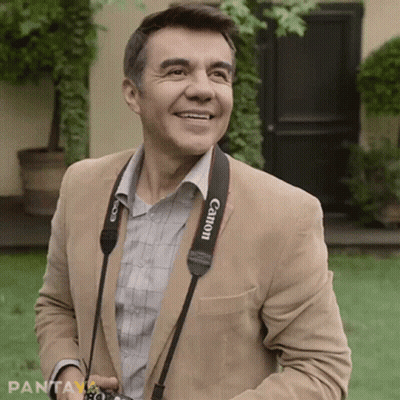 Man With Canon Camera Strap Smiling GIF