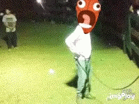 Man With Cartoon Face On Head Standing In Field At Night GIF