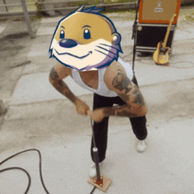 Man With Cartoon Otter On Head At Microphone GIF