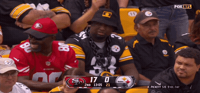 Man With Chain Watching Football In Stadium GIF