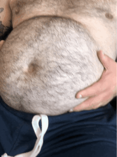Man With Chest Tattoo Holding Stomach GIF