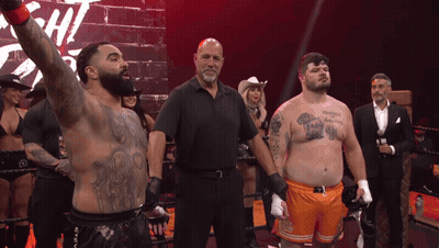Man With Chest Tattoo In Boxing Ring With Referee GIF
