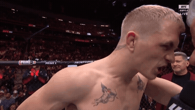 Man With Chest Tattoo In Front Of UFC Ring GIF