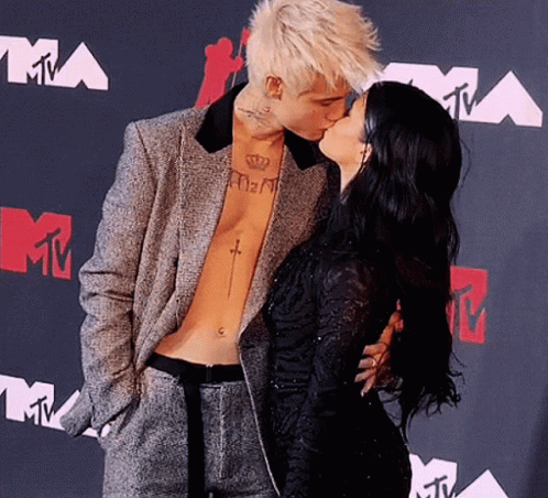 Man With Chest Tattoo Kissing Woman GIF