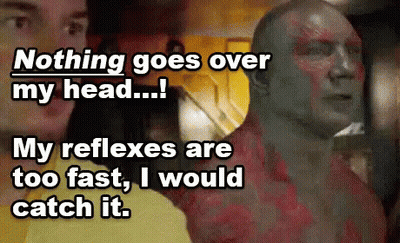 Man With Chest Tattoo Next To Another Man At Yellow Wall GIF