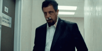 Man With Cigarette Walks Past Edna James Sign GIF