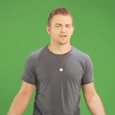 Man With Circle Necklace In Front Of Green Screen GIF