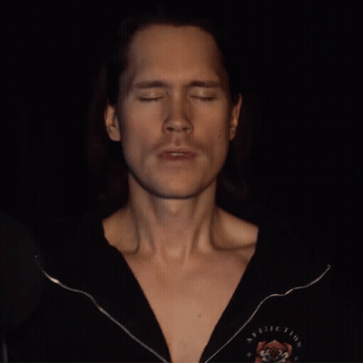 Man With Closed Eyes In Black Rolling Stones Shirt GIF