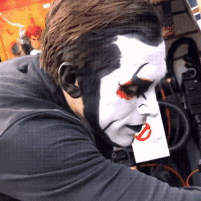 Man With Clown Face Holding Paper GIF