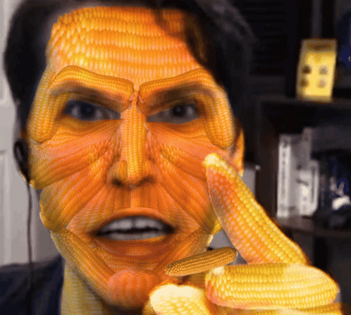 Man With Corn On The Cob Face Pointing GIF