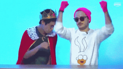 Man With Crown Beside Man In Cartoon Sweater GIF