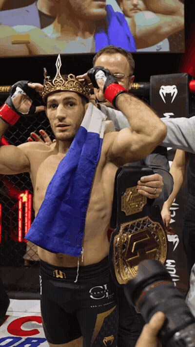 Man With Crown Holding Flag And UFC Belt GIF