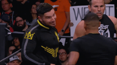 Man With Crown Jacket In Front Of Sign Saying W GIF