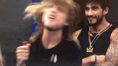 Man With Crown Necklace Next To Another Man GIF