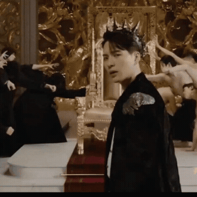 Man With Crown Standing In Front Of Throne GIF