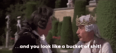 Man With Crown Talking To Man In Tuxedo GIF