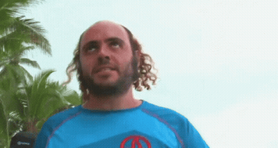 Man With Curly Hair And Beard In Blue Shirt With Red Circle GIF
