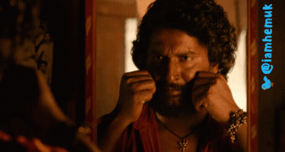 Man With Curly Hair And Beard In Front Of Twitter Logo GIF