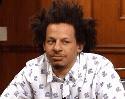 Man With Curly Hair And Beard In White Patterned Shirt GIF