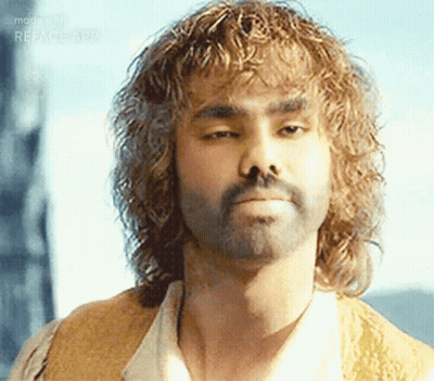Man With Curly Hair And Beard Looking At Camera GIF