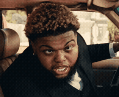 Man With Curly Hair And Beard Sitting In Car GIF