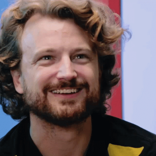 Man With Curly Hair And Beard Smiling GIF