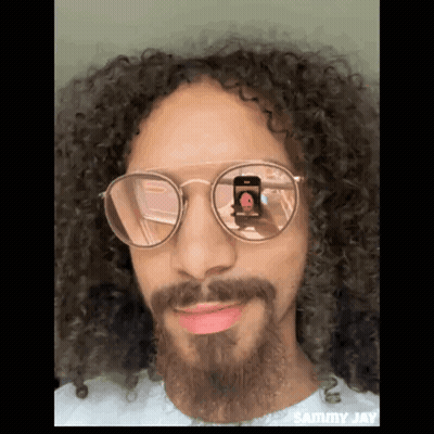 Man With Curly Hair And Beard Taking Photo GIF