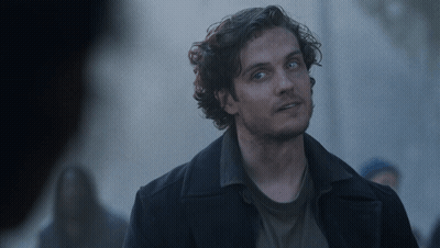 Man With Curly Hair And Blue Eyes In Black Coat GIF